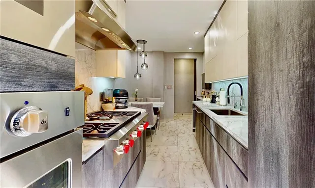 a kitchen with stainless steel appliances granite countertop a stove and a sink
