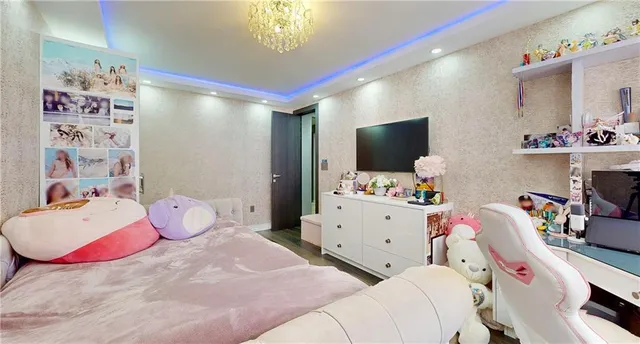 a bedroom with a bed and flat screen tv