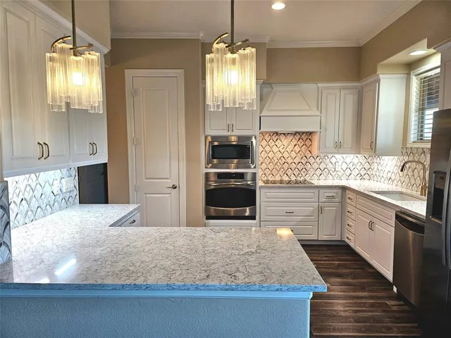 a kitchen with kitchen island granite countertop wooden cabinets and refrigerator