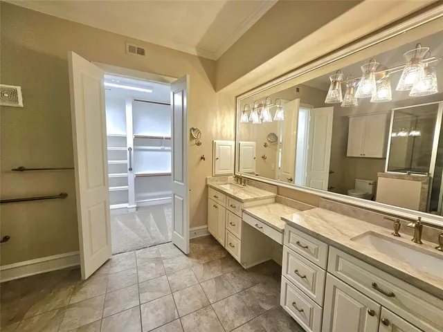 a spacious bathroom with a granite countertop sink and a mirror