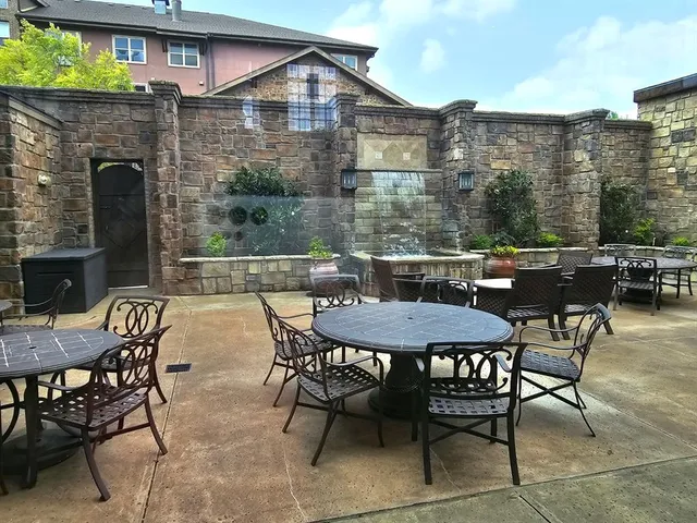 a view of a patio with table and chairs and potted plants