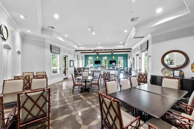 a view of a dining room with furniture and a large window