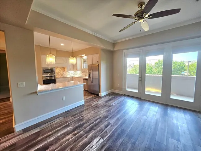 a view of a kitchen with a sink and wooden floor