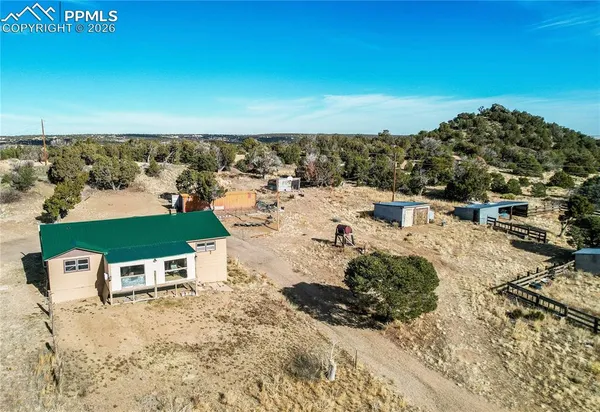 an aerial view of a house with a yard