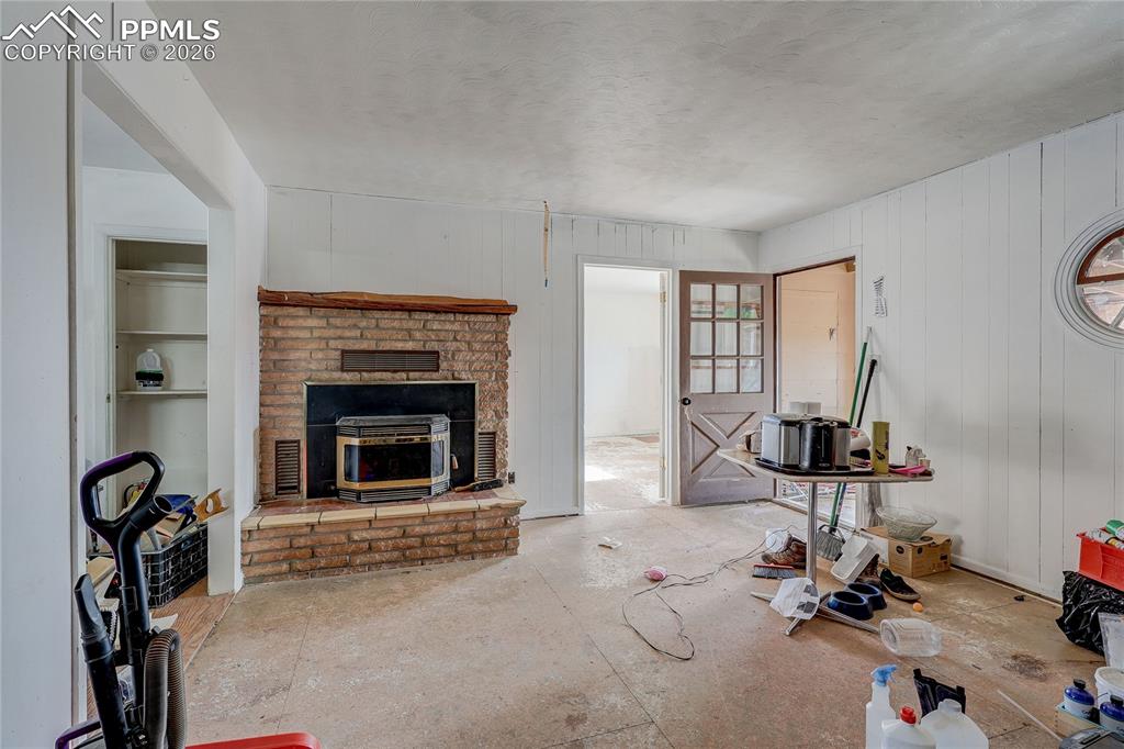 952 Twin Lakes Road Walsenburg, CO 81089 - Photo 13 of 34 a room with gym equipment and a fireplace