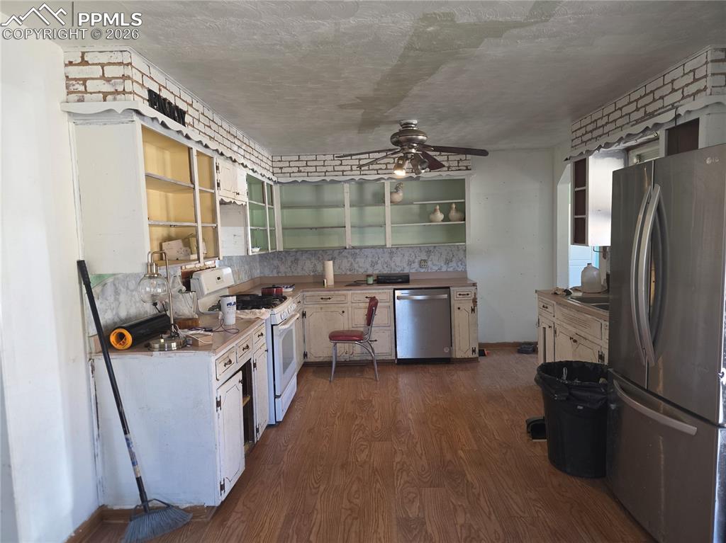 952 Twin Lakes Road Walsenburg, CO 81089 - Photo 9 of 34 a kitchen with stainless steel appliances a sink stove and refrigerator