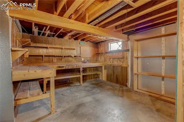a view of a room with chairs and table