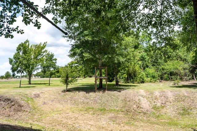 a aerial view of a house with yard and lake view