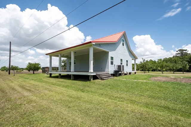 a view of a house with a yard and sitting area
