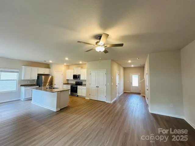 a view of a kitchen with a sink and a stove top oven