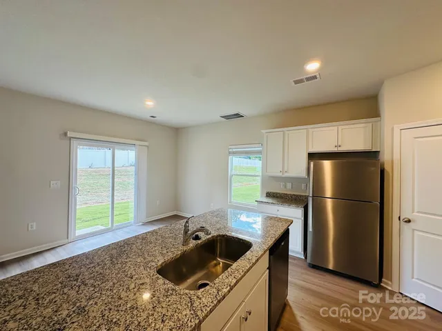 a kitchen with a refrigerator and a sink