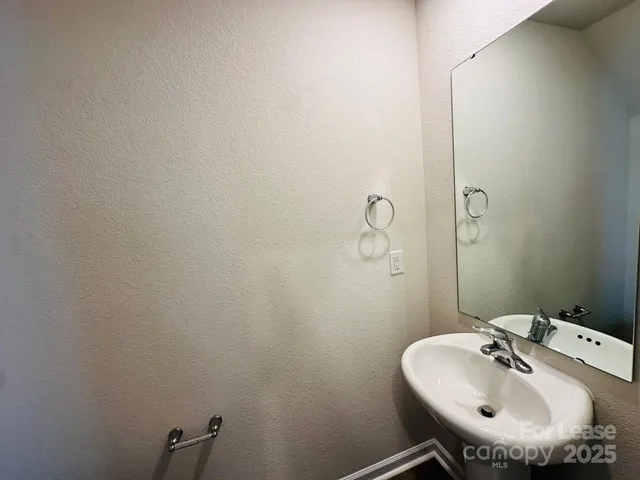 a bathroom with a sink and mirror