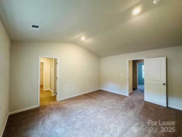 an empty room with closet and wooden door