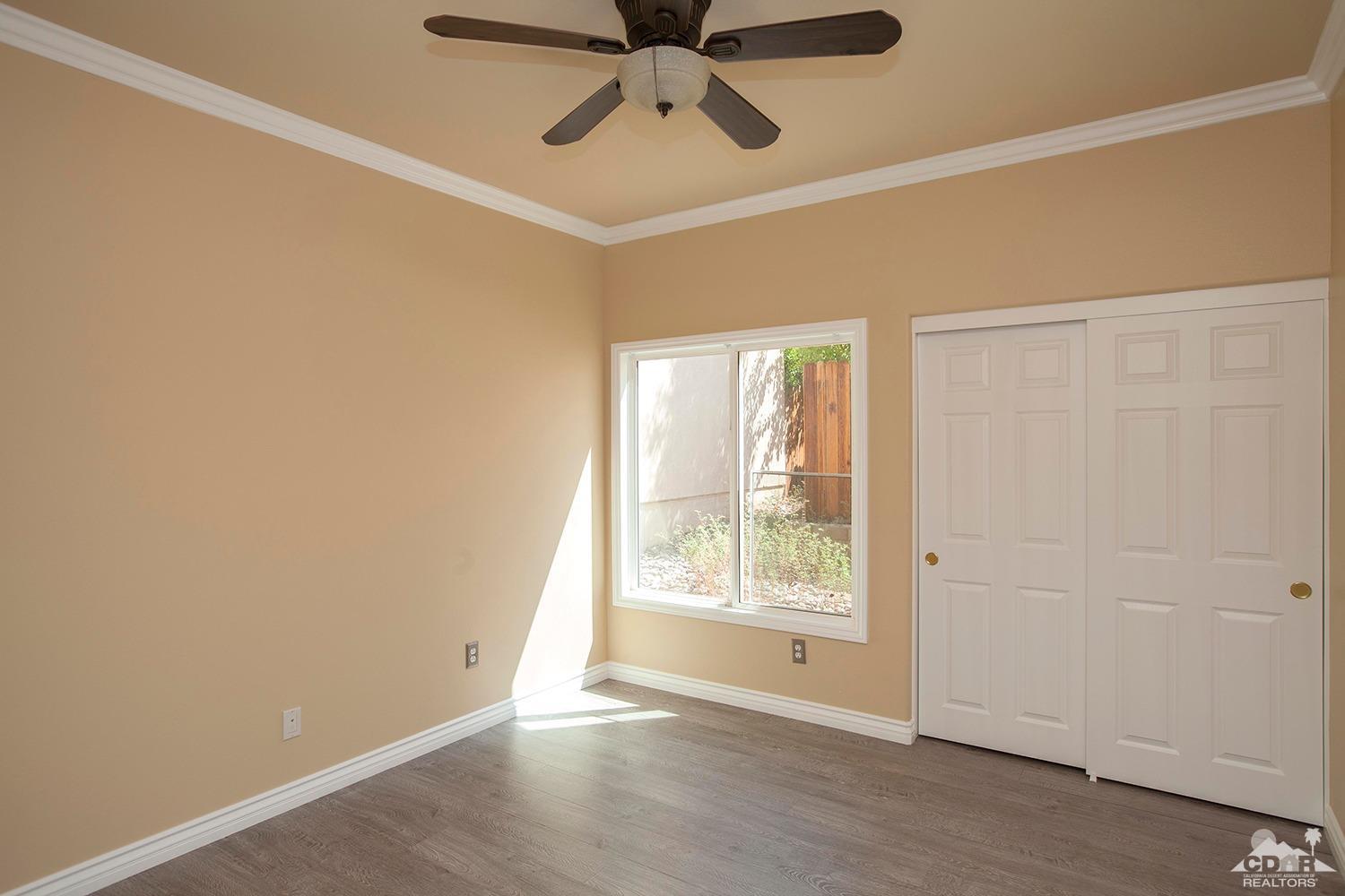 79338 Cool Reflection La Quinta, CA 92253 - Photo 12 of 16 an empty room with a window and a fan