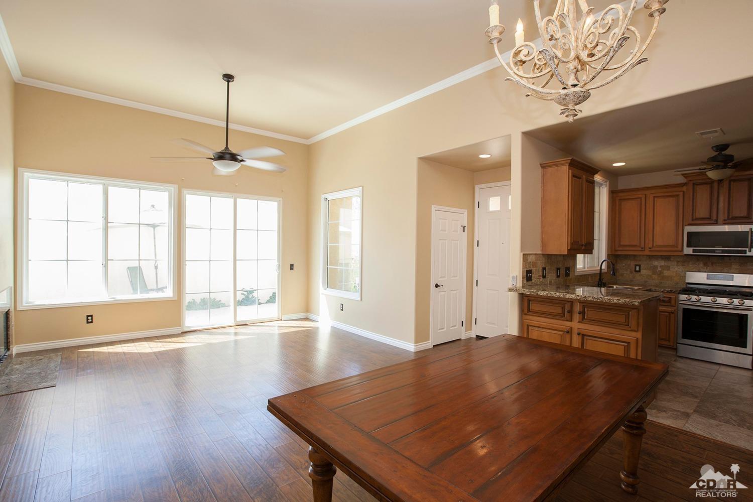 79338 Cool Reflection La Quinta, CA 92253 - Photo 5 of 16 a living room with stainless steel appliances kitchen island granite countertop furniture and a wooden floor