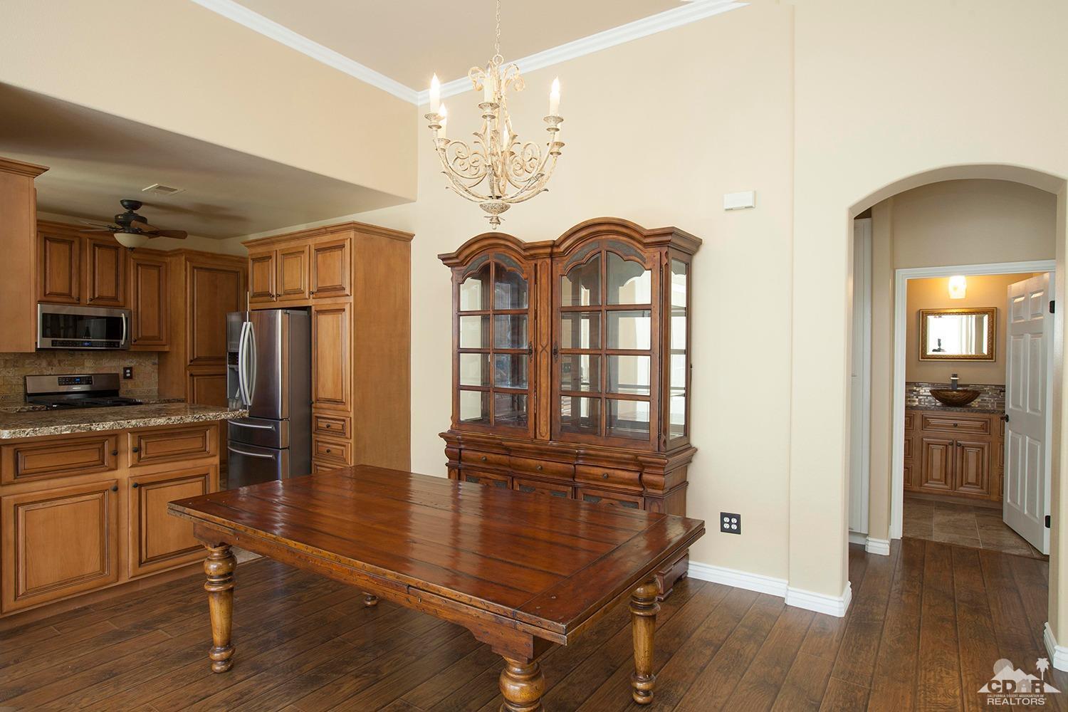 79338 Cool Reflection La Quinta, CA 92253 - Photo 9 of 16 a view of a kitchen with refrigerator and wooden floor