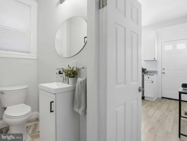 a bathroom with a sink a toilet and a mirror