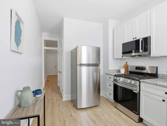 a kitchen with a refrigerator stove and microwave