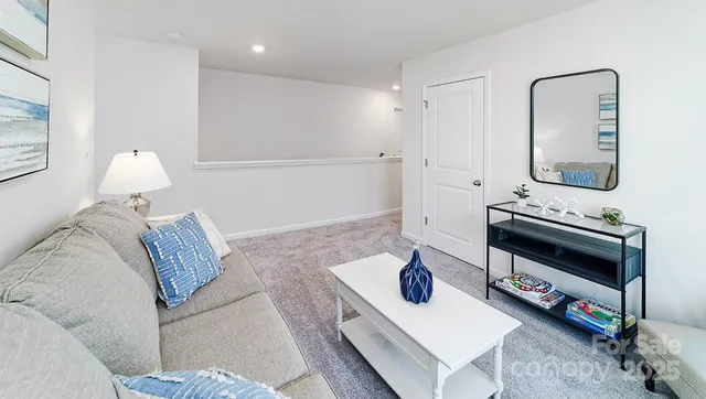 a living room with furniture and a mirror