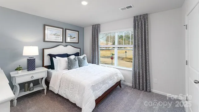 a bedroom with a bed and a large window