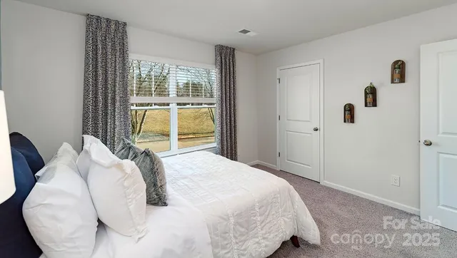 a bedroom with a bed and lamp