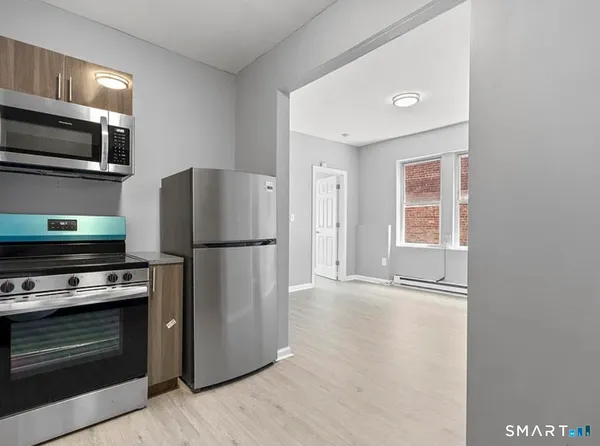 a kitchen with a refrigerator stove and microwave
