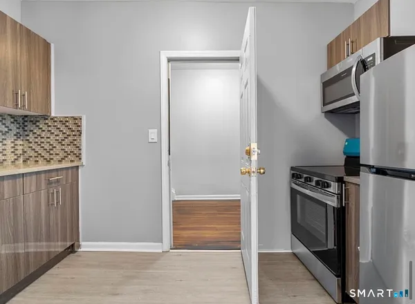 a kitchen with a stove and a refrigerator