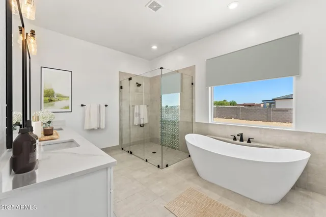 a spacious bathroom with a double vanity sink mirror and double