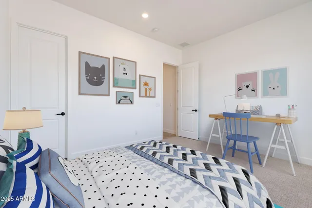 a bedroom with a bed and a table in it