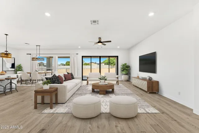 a living room with furniture flat screen tv and a large window