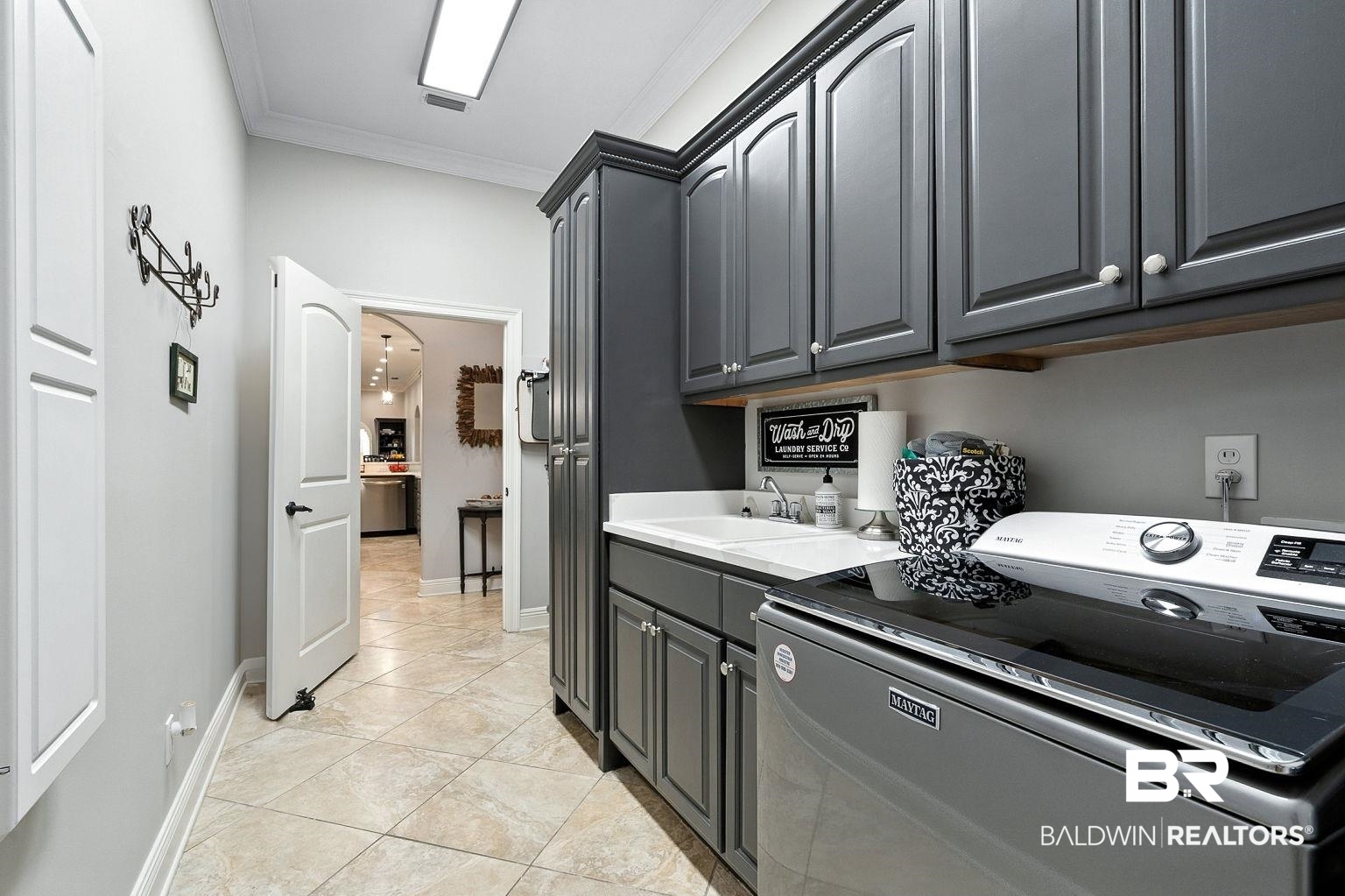 23357 Carnoustie Drive Foley, AL 36535 - Photo 73 of 99 Laundry room with washer / dryer, cabinet space, ornamental molding, and light tile patterned floors