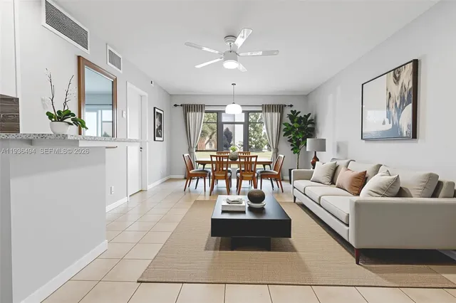 a living room with furniture and view of kitchen