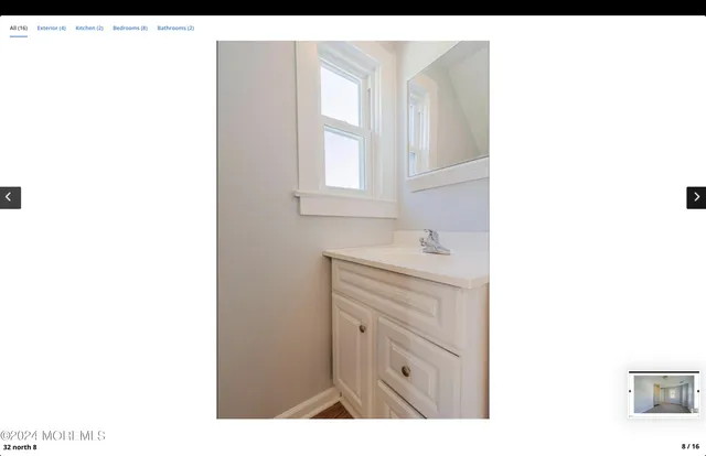 a bathroom with a sink a mirror and a vanity