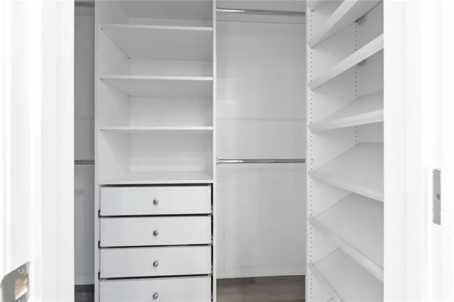 a view of walk in closet with empty racks