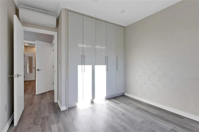 a view of an empty room and wooden floor