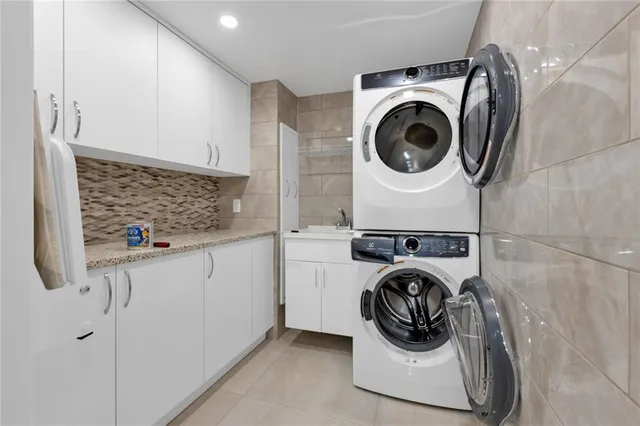 a utility room with sink dryer and washer