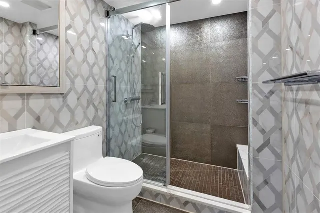 a bathroom with a toilet and a shower