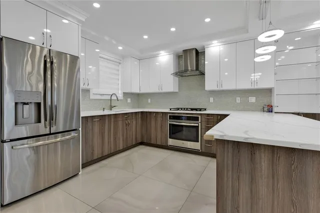 a kitchen with stainless steel appliances a refrigerator sink and microwave
