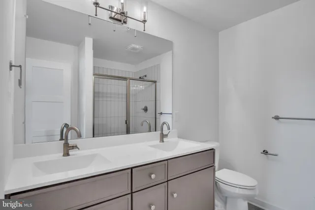 a bathroom with a sink toilet and a mirror
