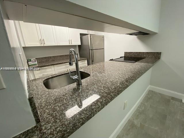 10801 Southwest 109th Court, Unit D103 Miami, FL 33176 - Photo 5 of 12 a kitchen with a sink and a refrigerator