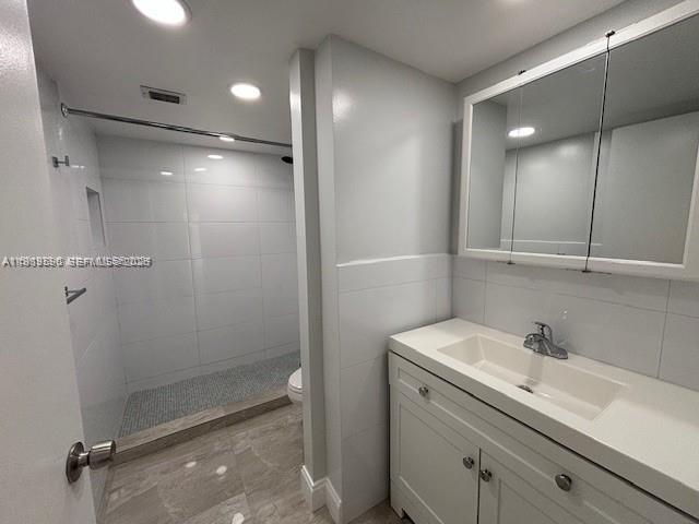 10801 Southwest 109th Court, Unit D103 Miami, FL 33176 - Photo 8 of 12 a bathroom with a shower sink vanity and mirror