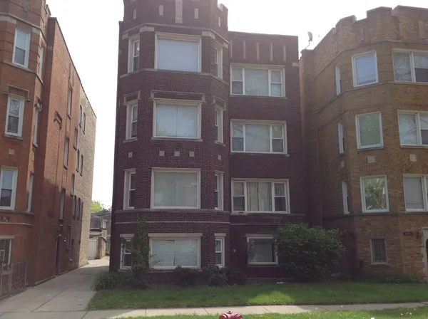 a view of a building with a yard