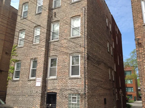 a view of a brick buildings with many windows