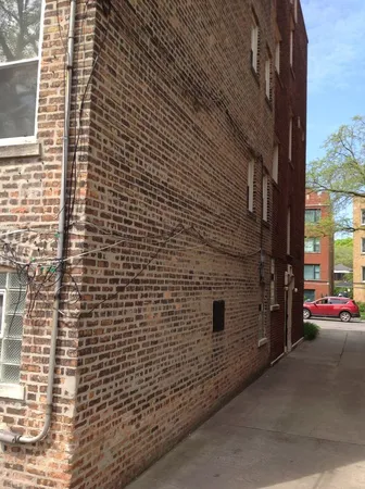 a view of street with brick wall