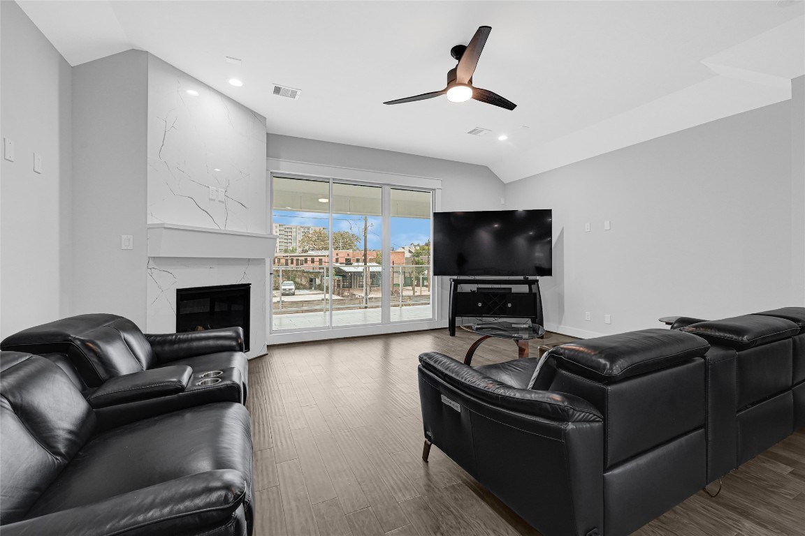 6118 Truro Street Houston, TX 77007 - Photo 12 of 39 a living room with furniture and a flat screen tv