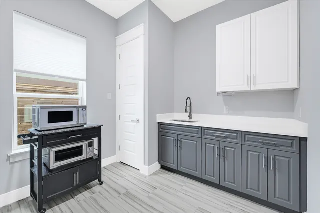 a kitchen with a refrigerator stove and wooden cabinets