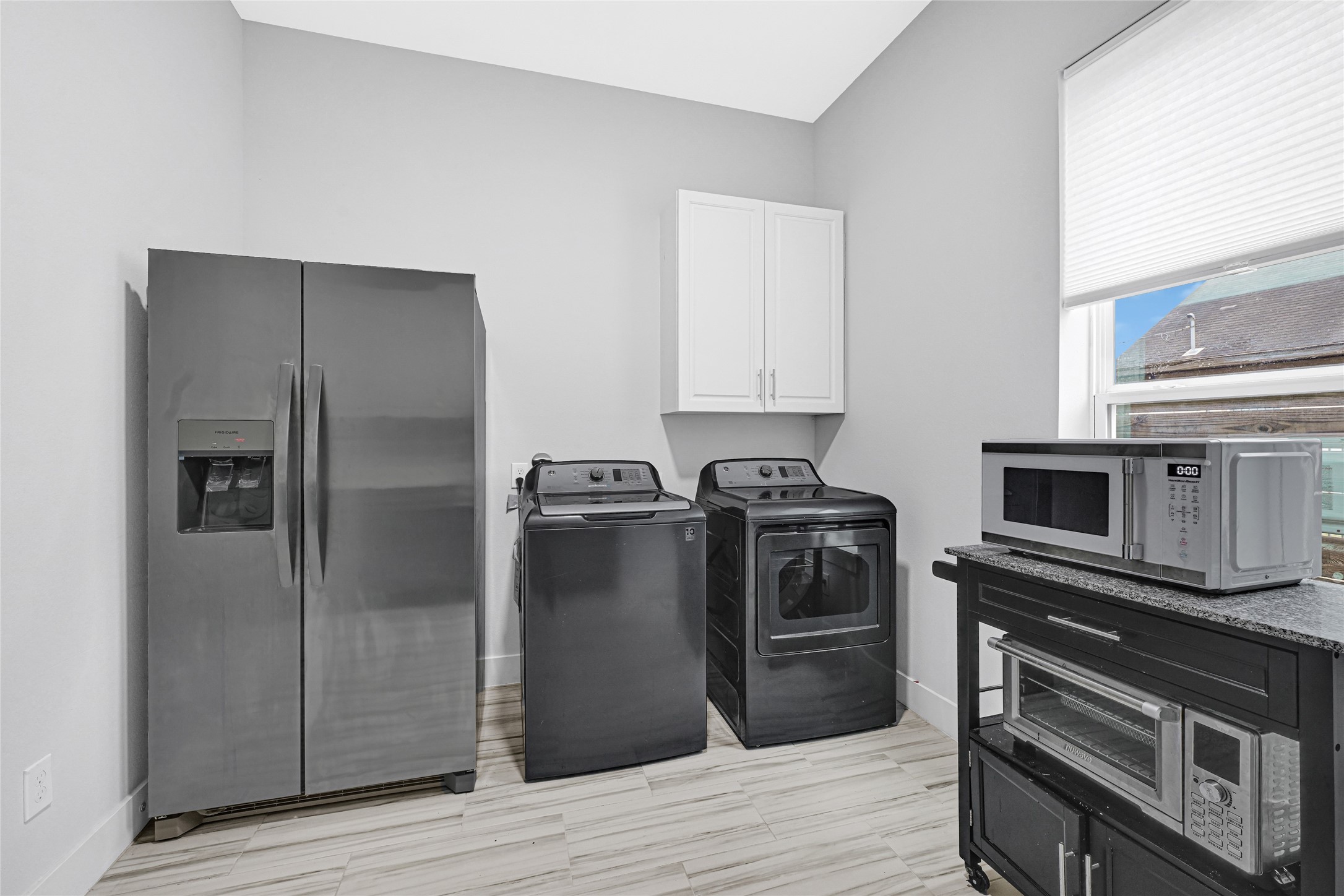 6118 Truro Street Houston, TX 77007 - Photo 26 of 39 a kitchen with a refrigerator stove and wooden cabinets