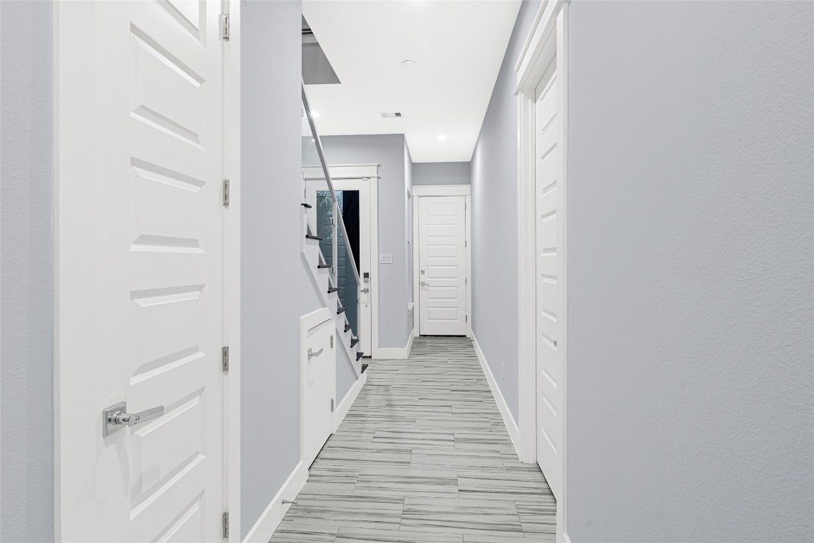 6118 Truro Street Houston, TX 77007 - Photo 3 of 39 a view of a hallway with wooden floor and staircase