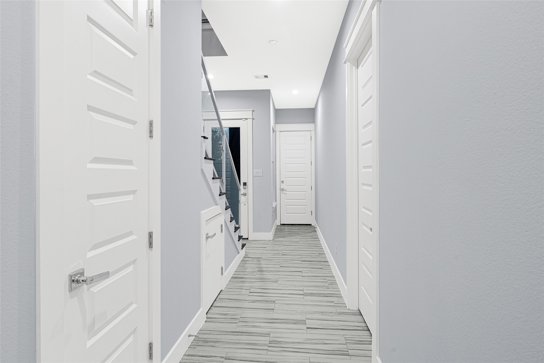 6118 Truro Street Houston, TX 77007 - Photo 3 of 39 a view of a hallway with wooden floor and staircase