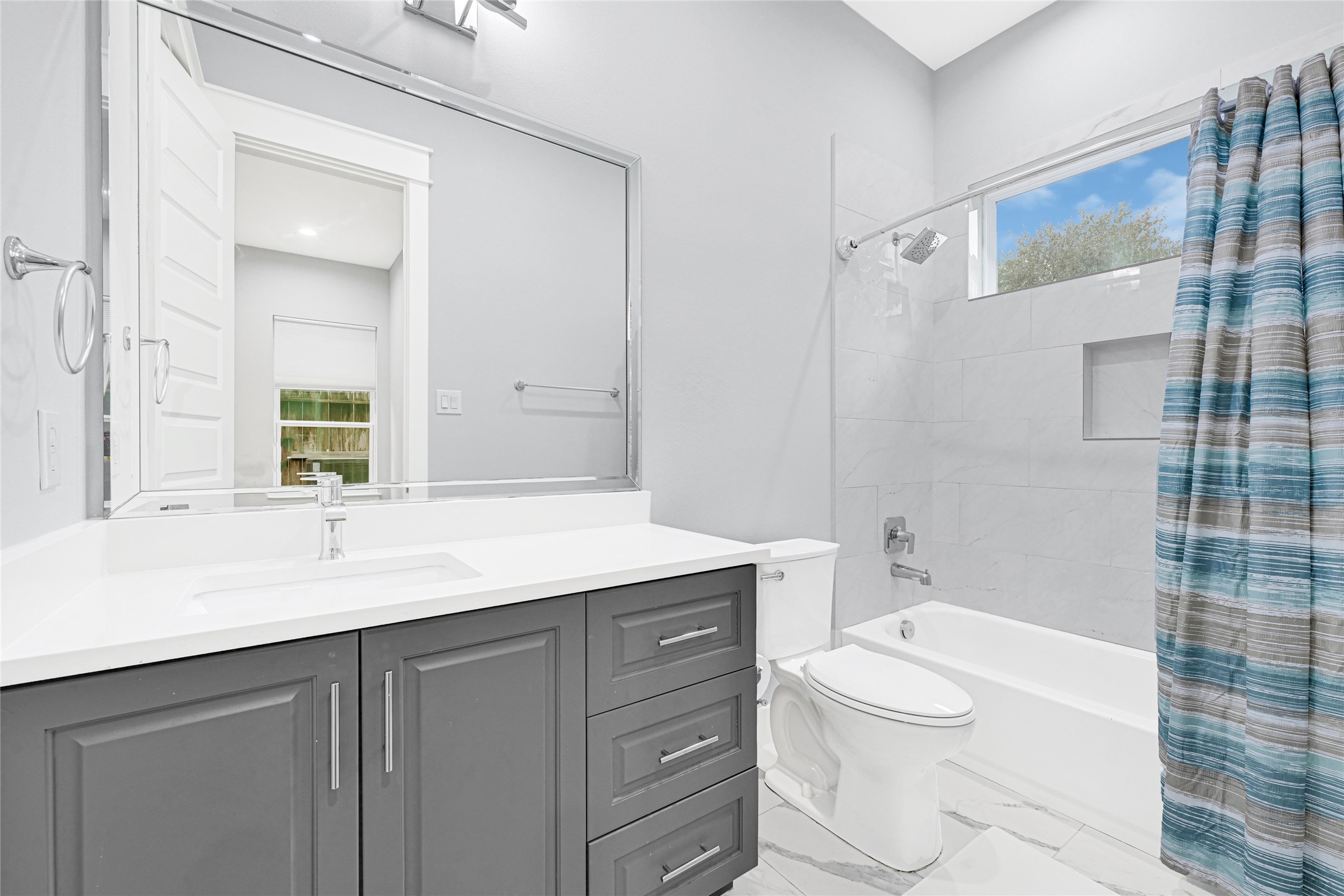 6118 Truro Street Houston, TX 77007 - Photo 32 of 39 a bathroom with a granite countertop sink toilet and shower